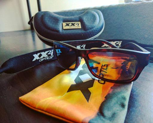 XX2i Optics Bahamas1 Sunglasses and Accessories Sitting on Table